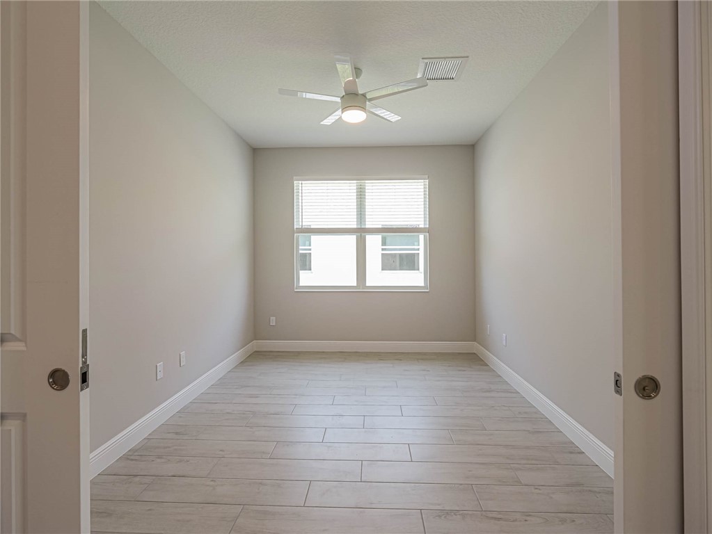 6422 High Pointe W Way Vero Beach, FL 32967 - Photo 18 of 33 wooden floor in an empty room with a window