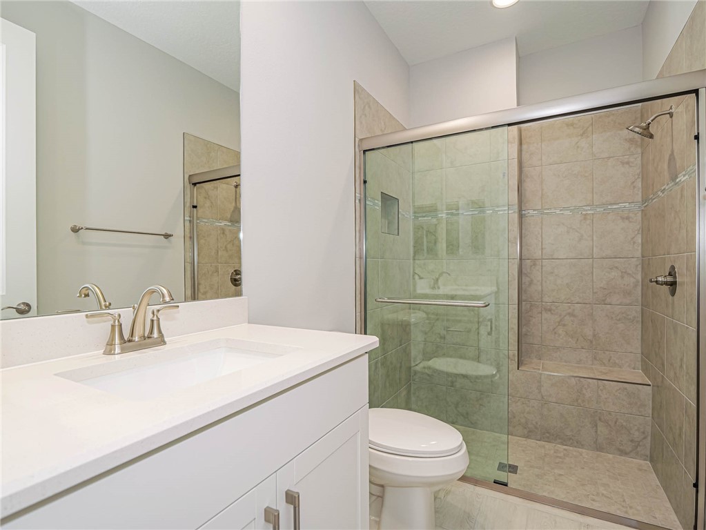 6422 High Pointe W Way Vero Beach, FL 32967 - Photo 25 of 33 a bathroom with a sink shower and a toilet