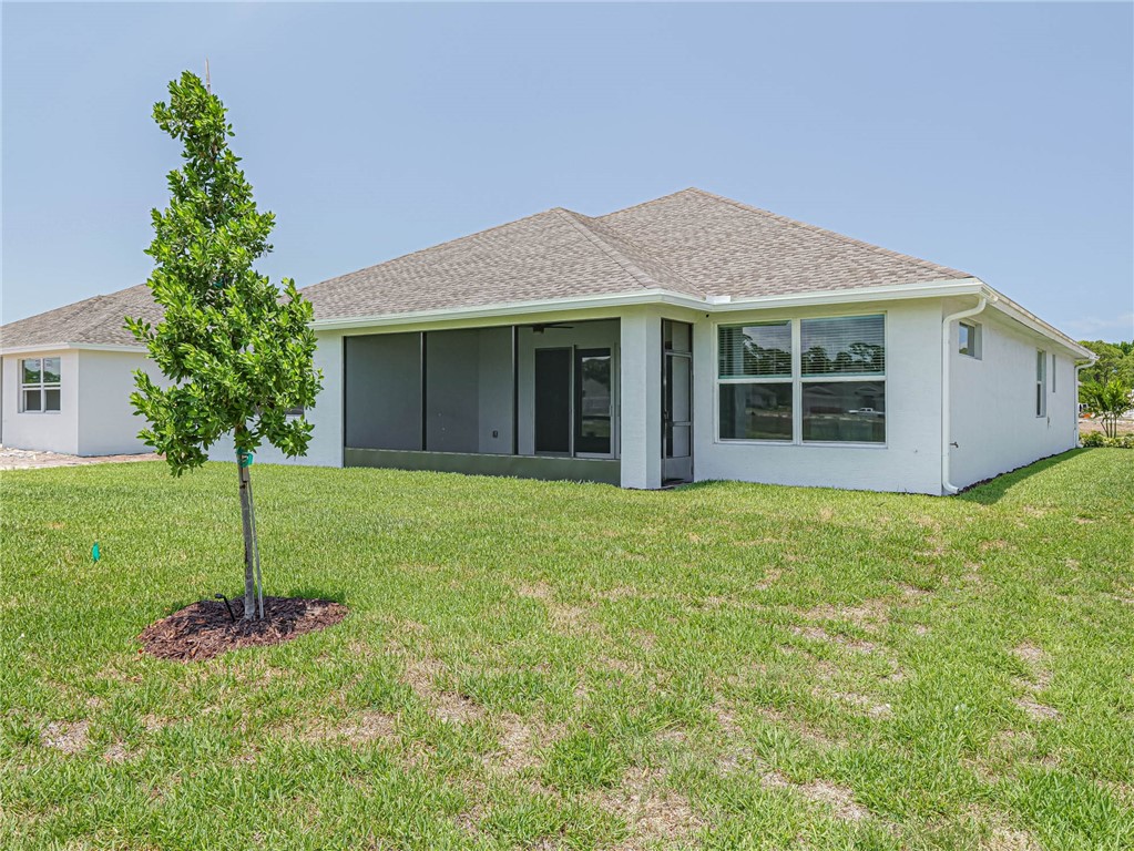 6422 High Pointe W Way Vero Beach, FL 32967 - Photo 31 of 33 front view of a house with a yard