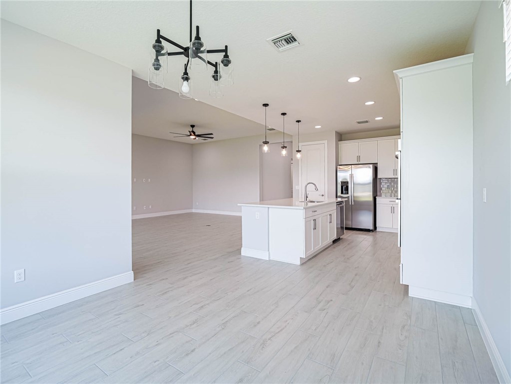 6422 High Pointe W Way Vero Beach, FL 32967 - Photo 8 of 33 a view of a kitchen with wooden floor