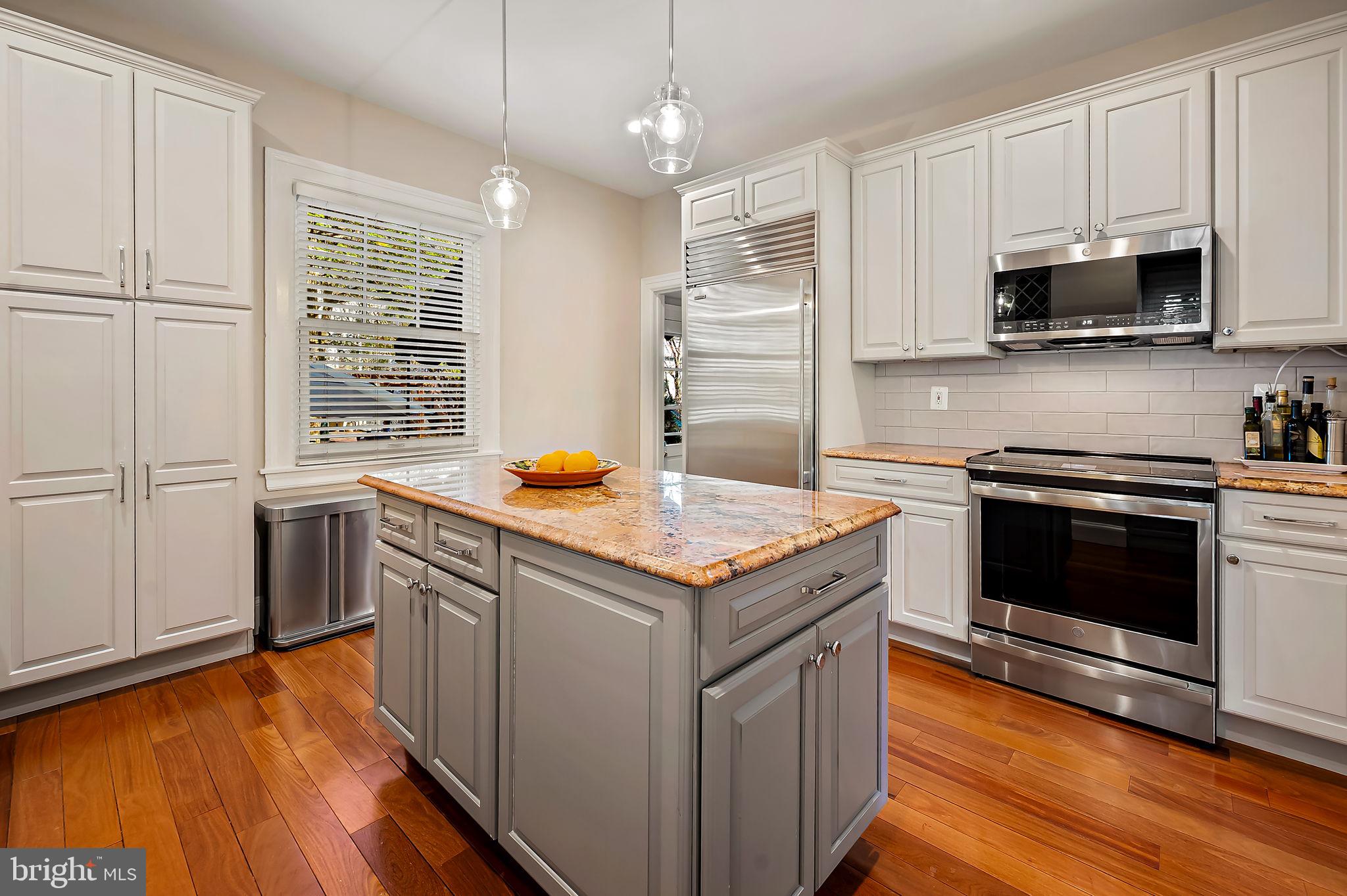 3923 Canterbury Road Baltimore, MD 21218 - Photo 13 of 42 a kitchen with stainless steel appliances granite countertop a stove and a microwave