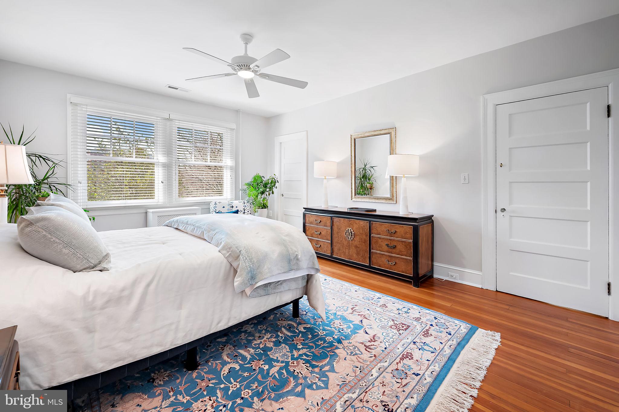 3923 Canterbury Road Baltimore, MD 21218 - Photo 22 of 42 a bedroom with a bed and wooden floor