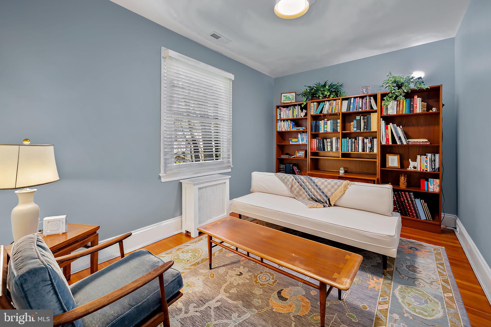 3923 Canterbury Road Baltimore, MD 21218 - Photo 24 of 42 a living room with furniture a rug and a bookshelf