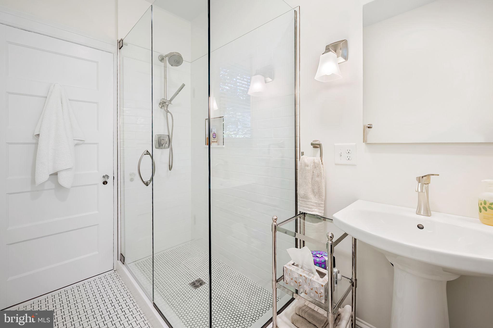 3923 Canterbury Road Baltimore, MD 21218 - Photo 27 of 42 a bathroom with a sink a shower and a mirror