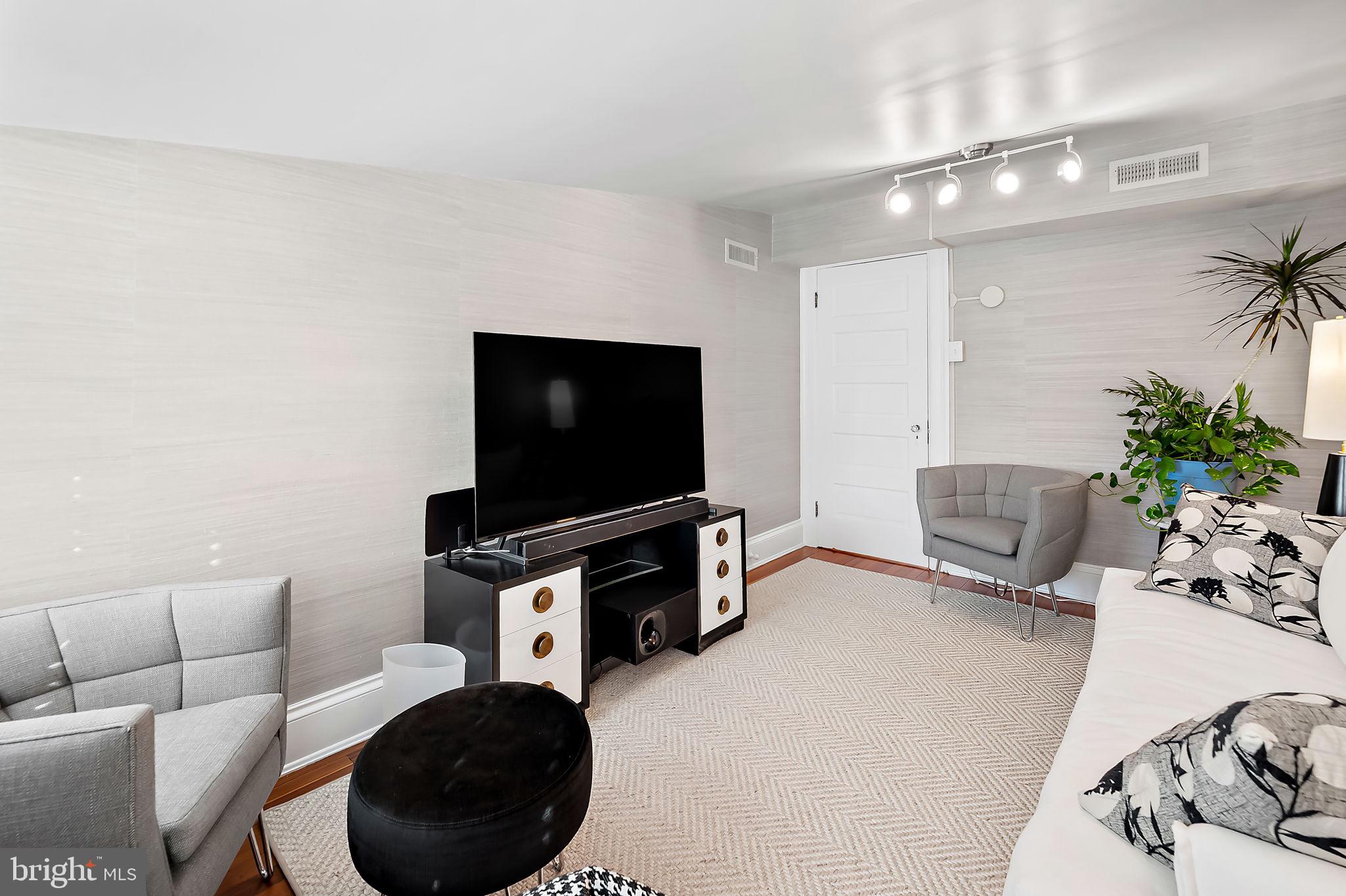3923 Canterbury Road Baltimore, MD 21218 - Photo 33 of 42 a living room with furniture and a flat screen tv