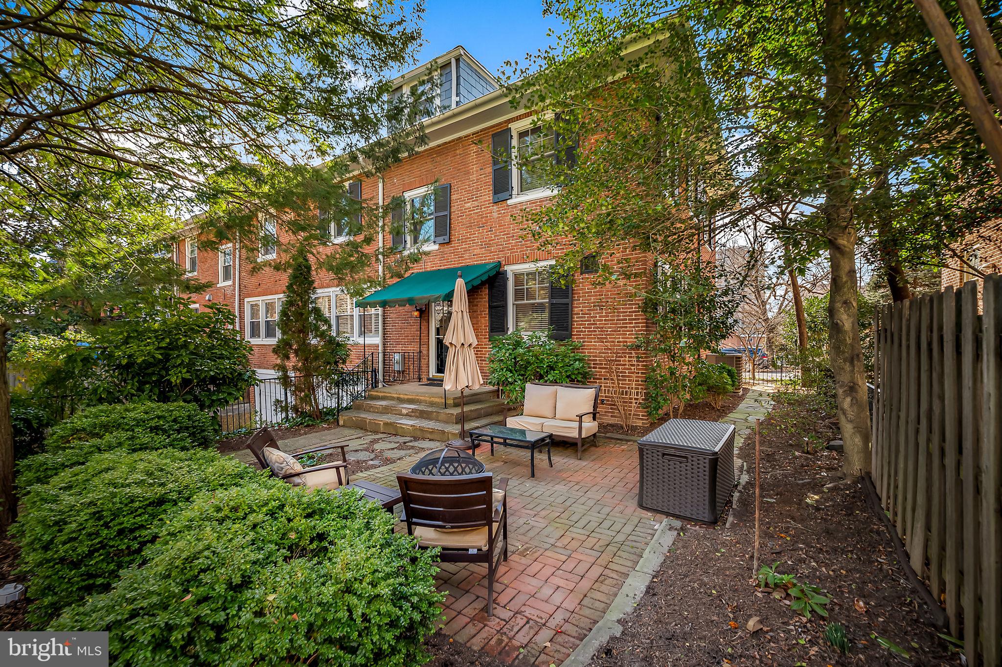 3923 Canterbury Road Baltimore, MD 21218 - Photo 37 of 42 a view of a patio with couches table and chairs under an umbrella