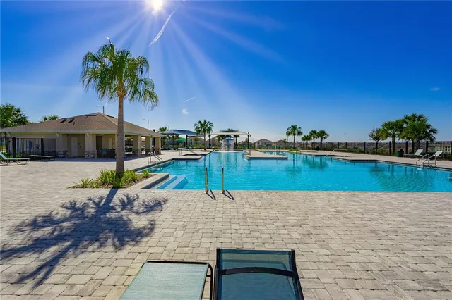 a view of a swimming pool with lounge chair