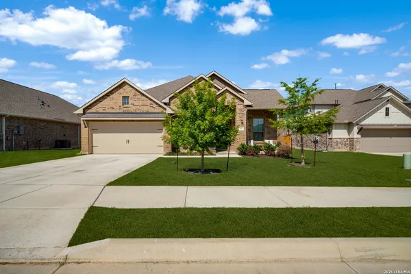 a front view of a house with a garden and yard