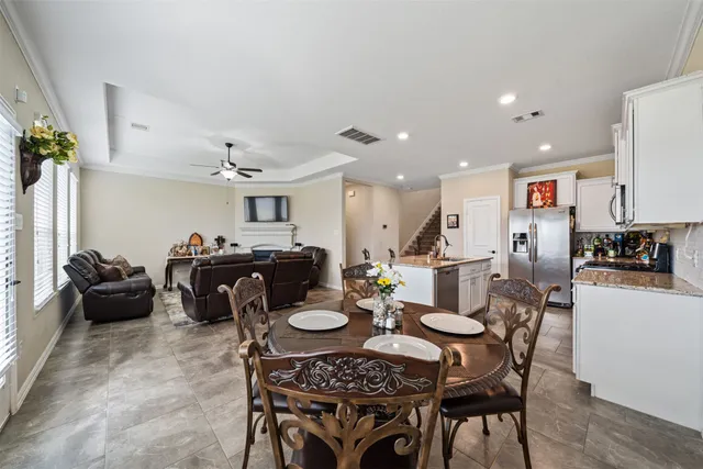 a living room with furniture and a view of kitchen