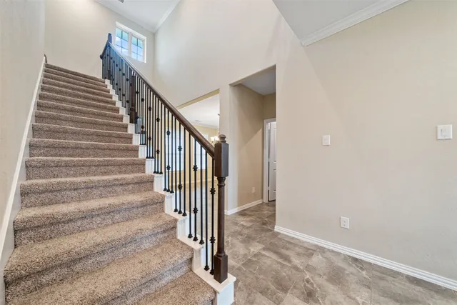 a view of a swimming pool with a chair and floor to ceiling window