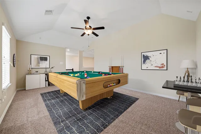 a view of a house with a big yard and a large tree
