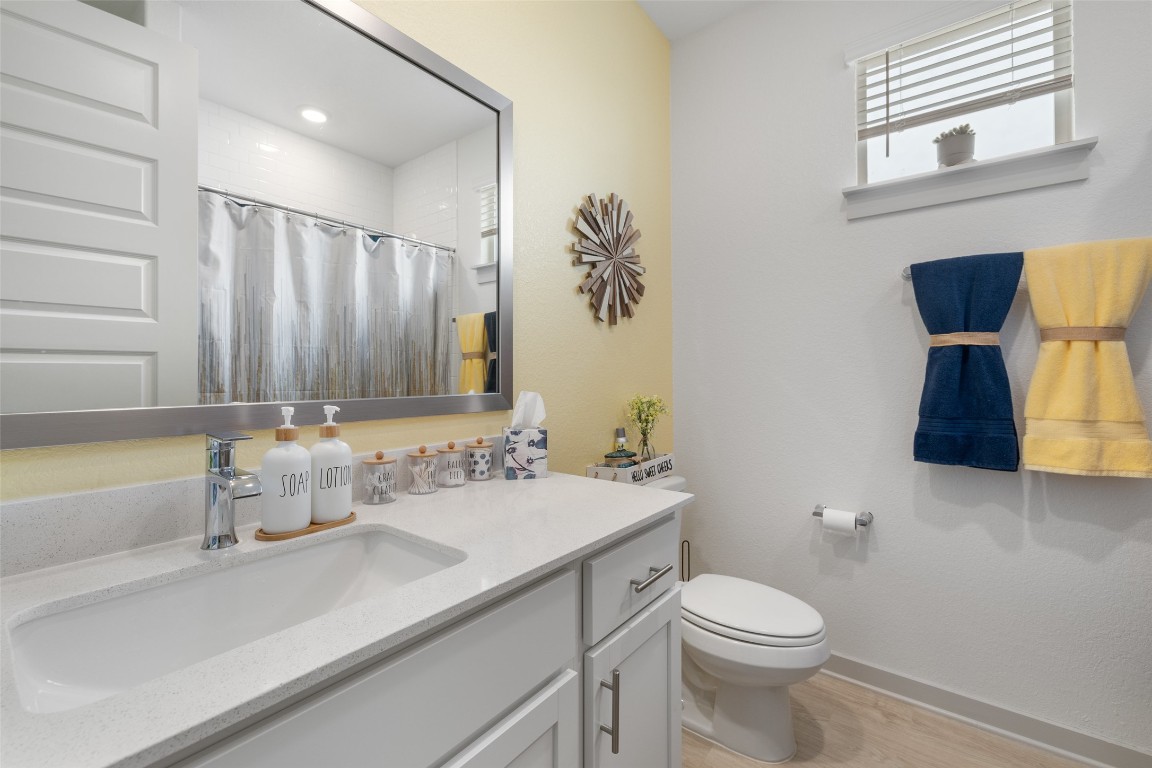 109 Rambling Rapids Drive Georgetown, TX 78628 - Photo 26 of 37 Bathroom featuring vanity, light wood-style flooring, and a shower with curtain