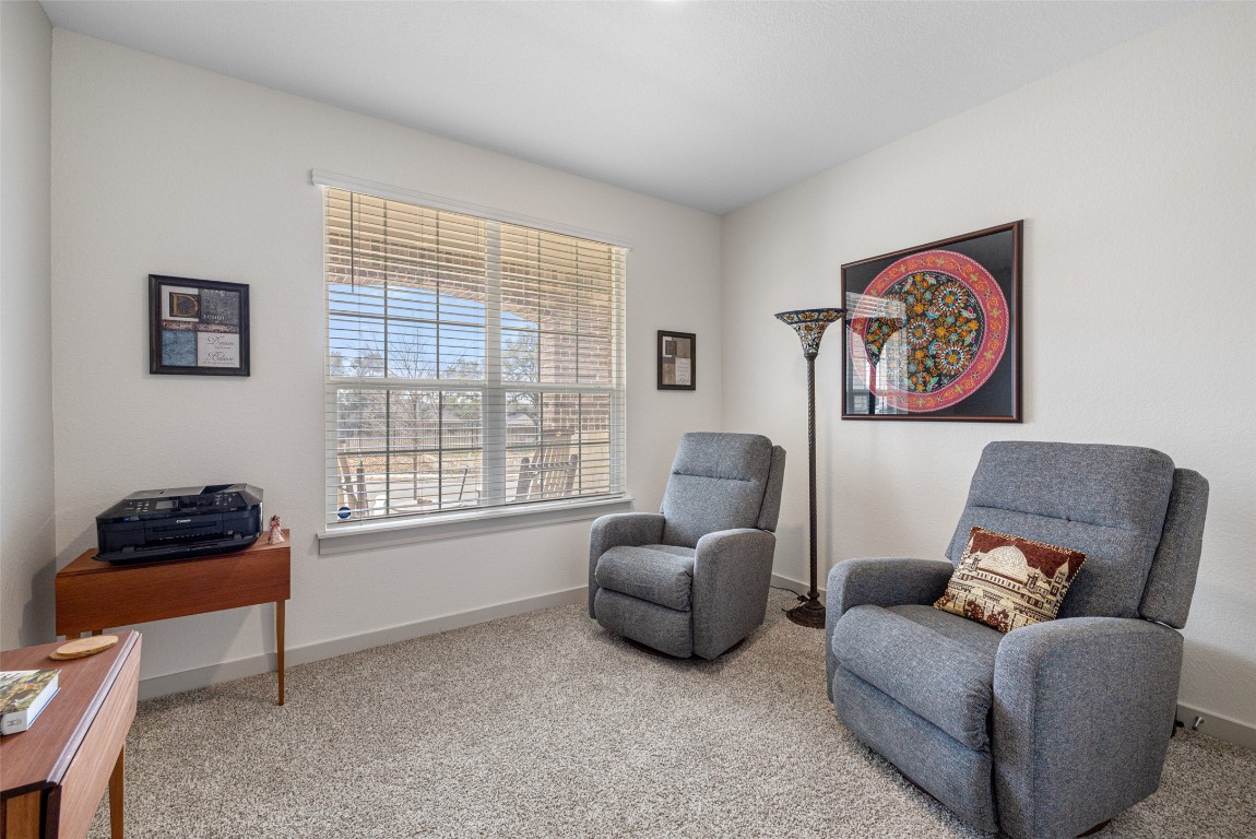 109 Rambling Rapids Drive Georgetown, TX 78628 - Photo 28 of 37 Living area featuring light colored carpet and baseboards