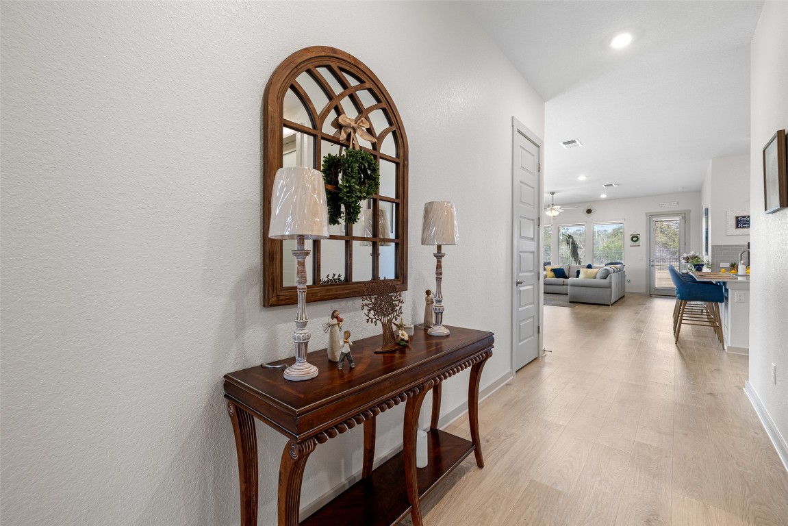 109 Rambling Rapids Drive Georgetown, TX 78628 - Photo 5 of 37 Hall with light wood-style floors, recessed lighting, and a textured wall