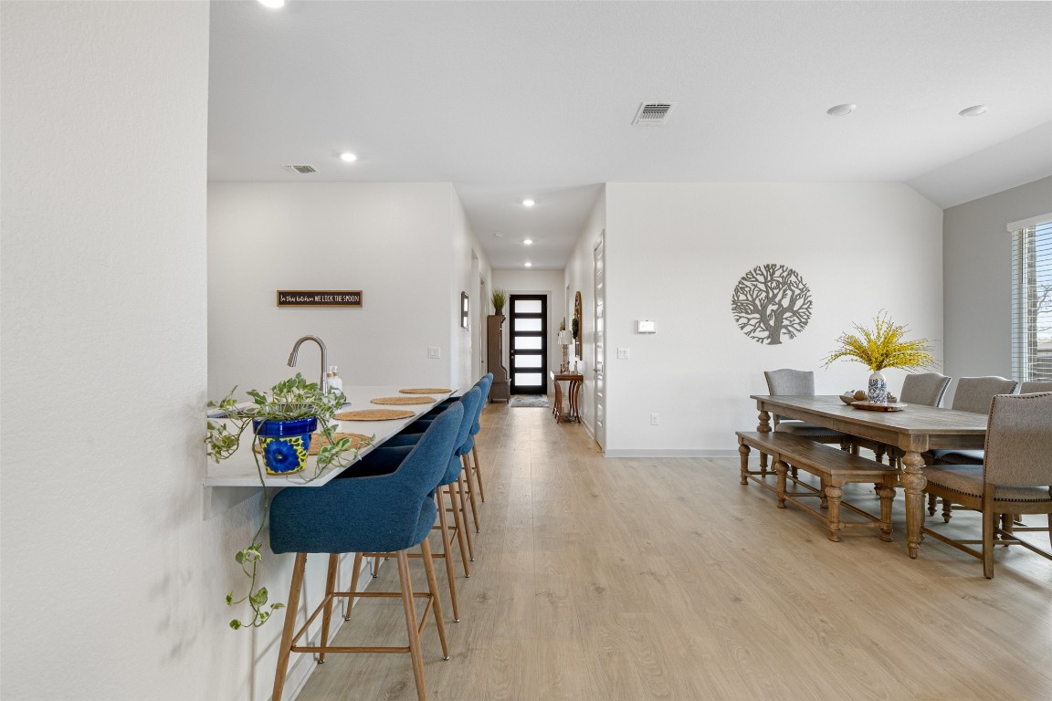 109 Rambling Rapids Drive Georgetown, TX 78628 - Photo 8 of 37 Dining space featuring light wood finished floors, healthy amount of natural light, and recessed lighting