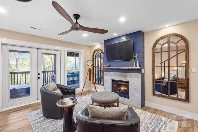a living room with furniture a fireplace and a flat screen tv