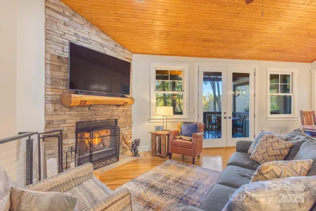 a living room with furniture wooden floor and a fireplace