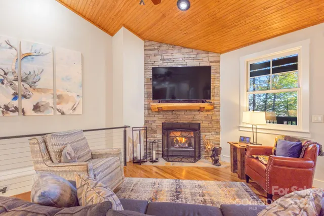 a living room with furniture fireplace and flat screen tv