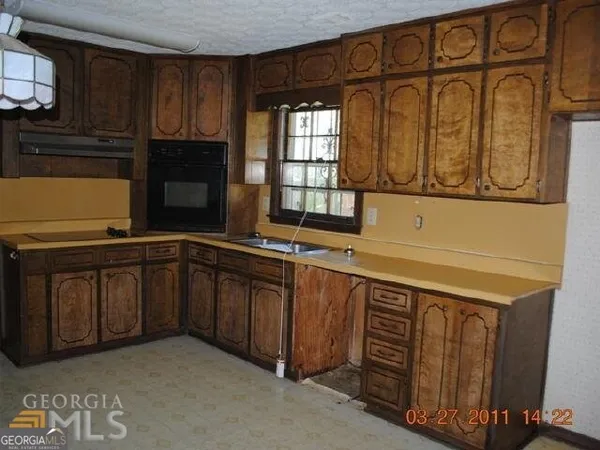 a kitchen with stainless steel appliances granite countertop a sink and cabinets