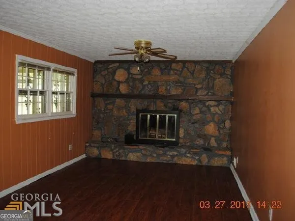 a room with a fireplace and wooden floor