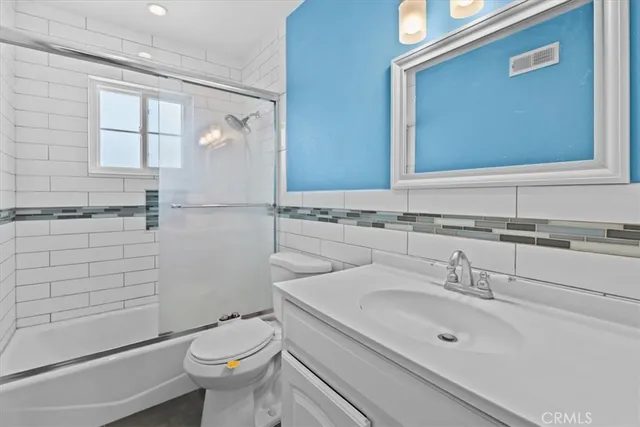 a bathroom with a sink toilet and mirror