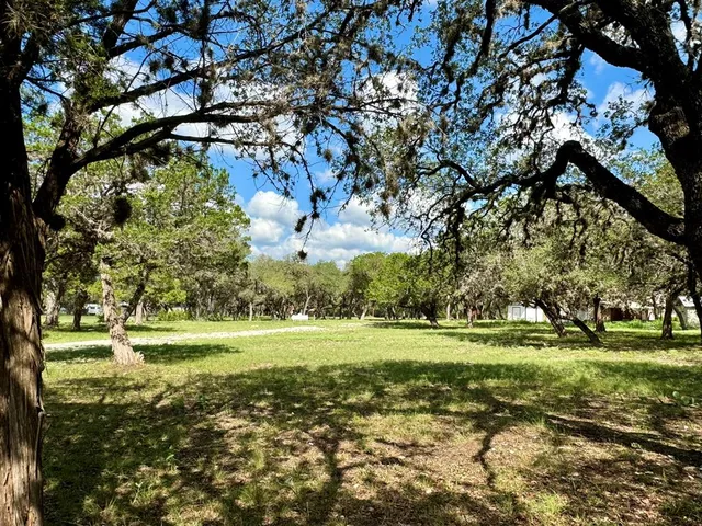 a view of a golf course with trees