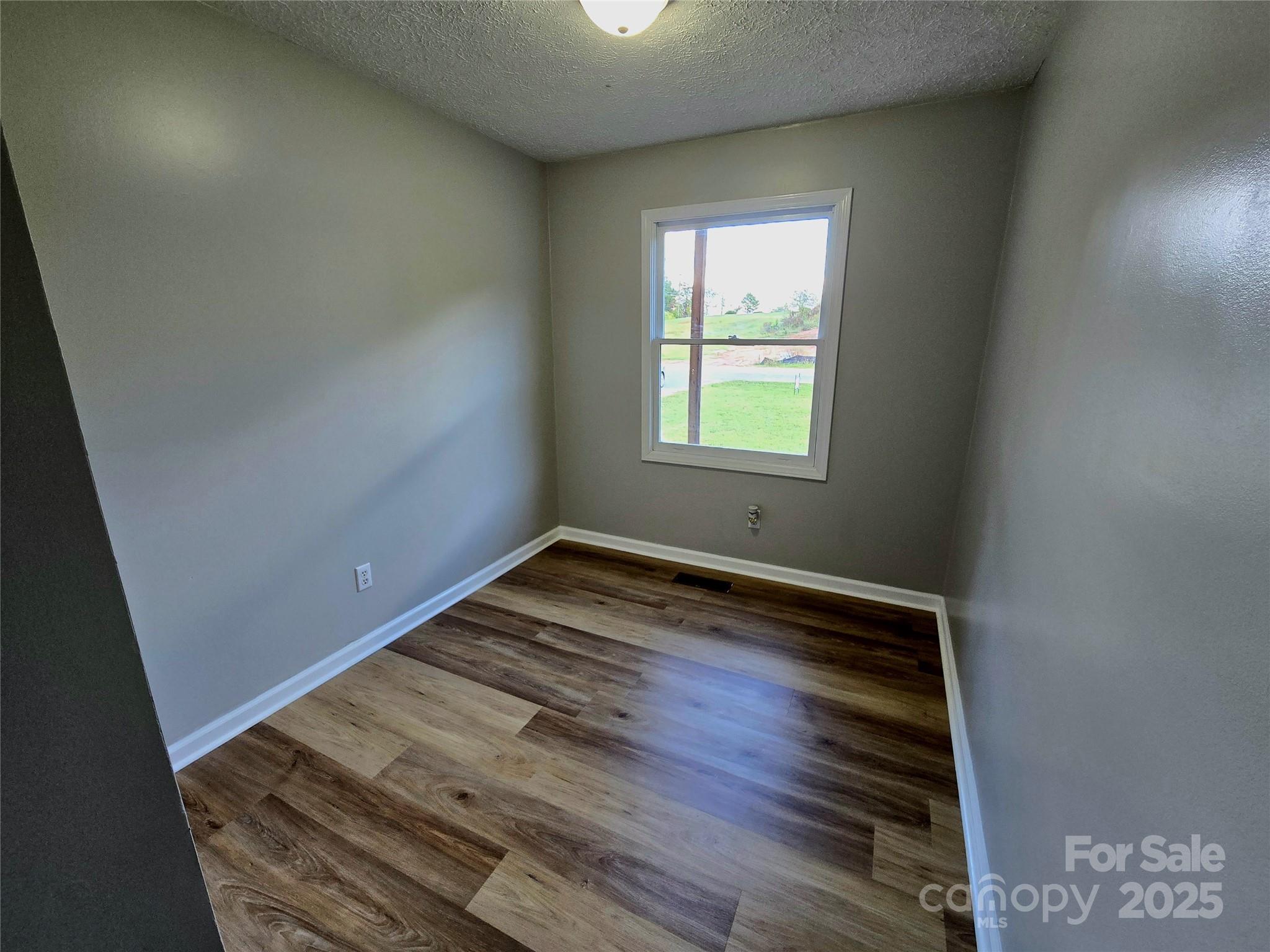 2363 Edna Street Catawba, NC 28609 - Photo 12 of 14 an empty room with wooden floor and windows