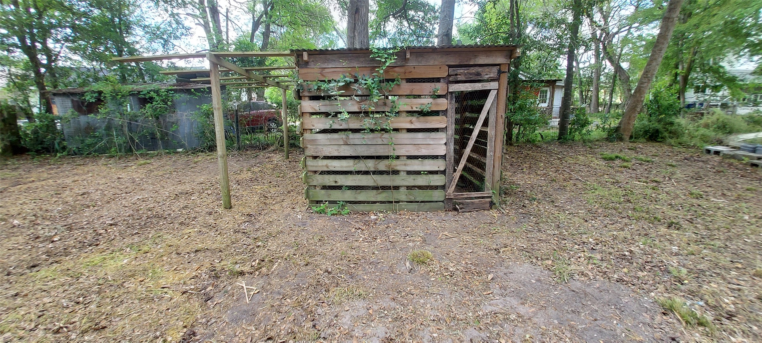 324 East Second Street Groveton, TX 75845 - Photo 13 of 20 a view of a wooden house with a yard and tree s