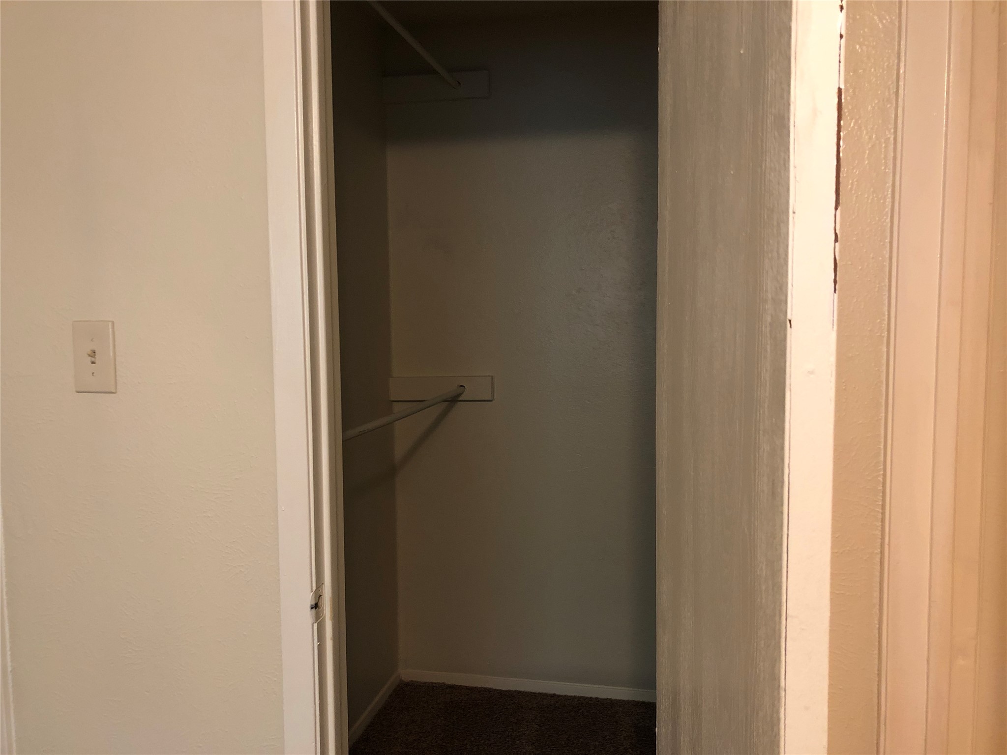 11510 Walnut Ridge Drive, Unit B Austin, TX 78753 - Photo 10 of 18 Functional storage space includes built-in shelving, hanging rods, and carpet flooring.