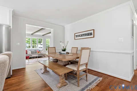 a dining room with furniture and wooden floor