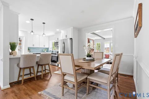 a large kitchen with stainless steel appliances and white cabinets