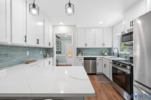 a kitchen with a sink stove and refrigerator