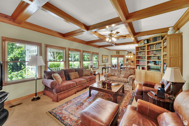 7740 Keswick Road Sandy, UT 84093 - Photo 24 of 74 Living area featuring a coffered wood-beam ceiling, extensive built-in wooden shelving, multiple windows with blinds, wood-finish flooring, and a ceiling fan