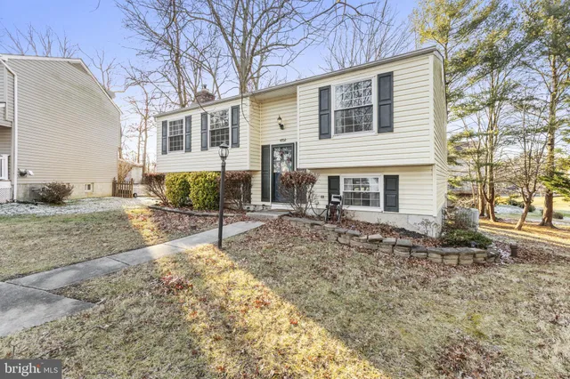 a large bed sitting in a bedroom next to a window