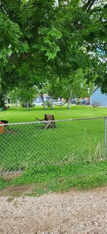 a view of field with trees in the background