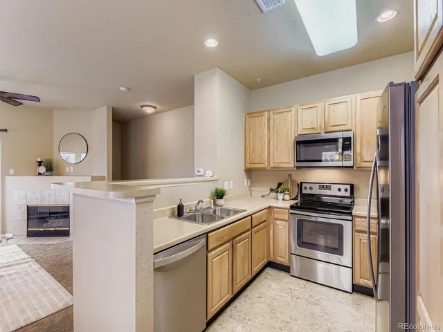 a kitchen with a sink stainless steel appliances and cabinets