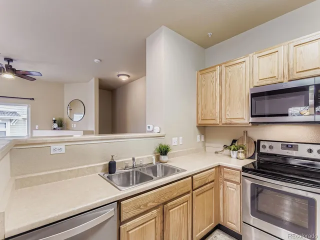 a kitchen with sink a stove and cabinets