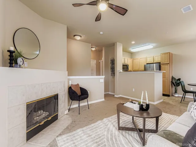 a living room with furniture and a fireplace