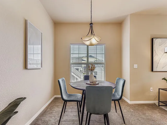 a view of a dining room with furniture window and outside view