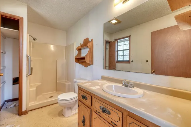 a bathroom with a sink toilet and shower