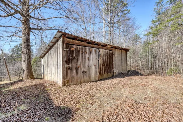 a view of a wooden house with a large trees
