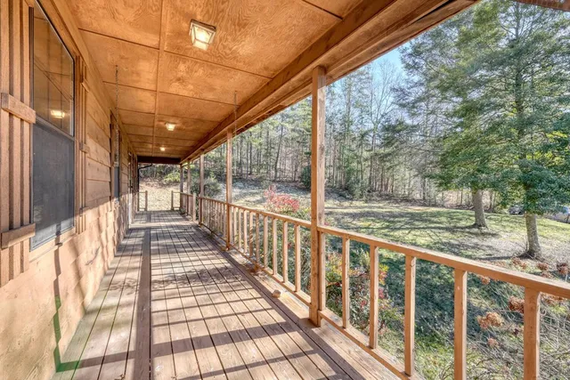 a view of a porch with wooden floor and fence