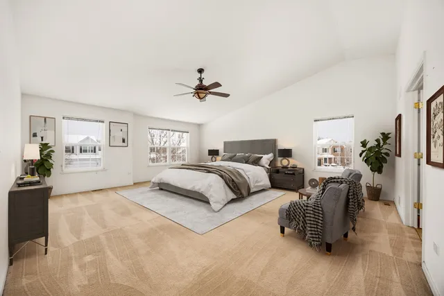 a spacious bedroom with a bed and couch