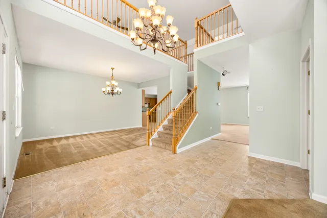a view of a livingroom with stairs and a ceiling fan