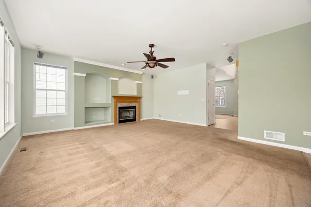 a view of an empty room with a fireplace
