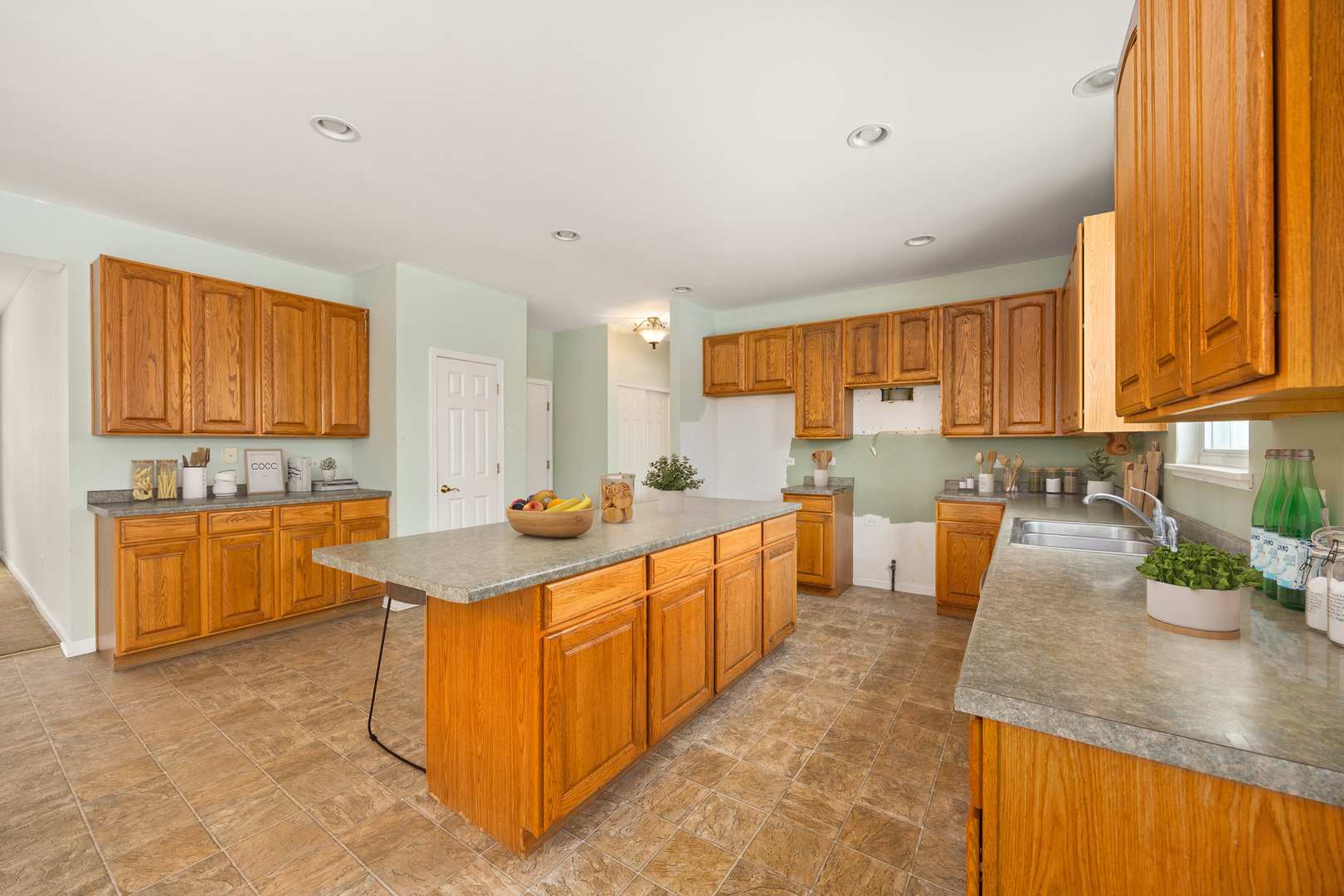 333 Claridge Circle Bolingbrook, IL 60440 - Photo 9 of 33 a large kitchen with stainless steel appliances granite countertop a sink counter space cabinets and a large window