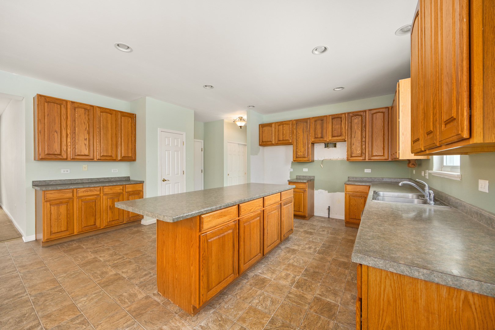 333 Claridge Circle Bolingbrook, IL 60440 - Photo 10 of 33 a large kitchen with stainless steel appliances granite countertop a sink stove and cabinets