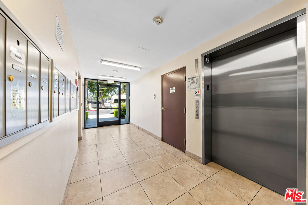 7122 Amigo Avenue Reseda, CA 91335 - Photo 2 of 16 a view of a hallway with wooden floor and a bathroom