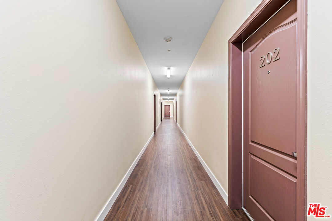 7122 Amigo Avenue Reseda, CA 91335 - Photo 3 of 16 a view of a hallway with wooden floor