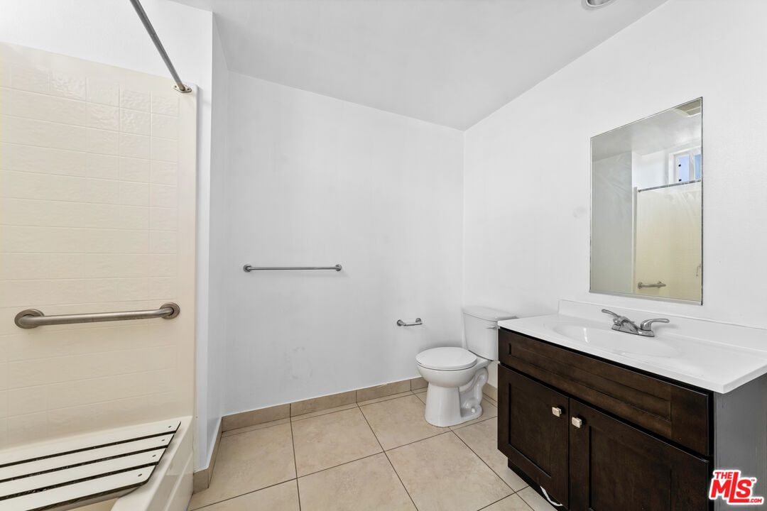 7122 Amigo Avenue Reseda, CA 91335 - Photo 7 of 16 a bathroom with a sink and a mirror